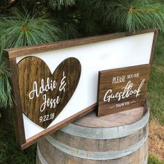 two wooden heart signs sitting on top of a barrel