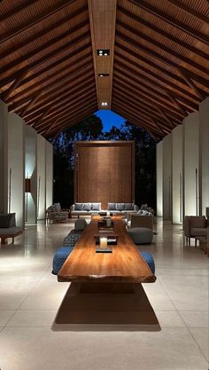 a living room filled with furniture and a wooden ceiling covered in wood planked ceilings