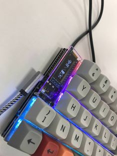 a computer keyboard with an illuminated key board attached to it