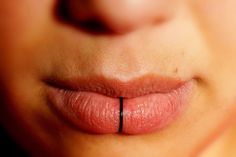 a woman's lip is shown with black lines on the tip of her tongue