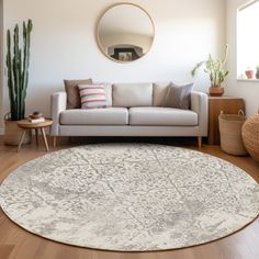 a living room with a white couch and round rug