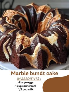 a marble bundt cake on a white plate with chocolate icing and caramel swirl