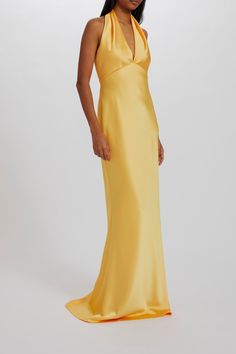 a woman in a long yellow dress