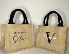 two burlap bags with black handles and the words, les attarbes de siljuma written on them