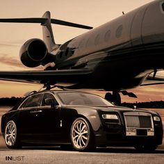 a rolls royce parked in front of an airplane