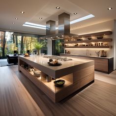 a modern kitchen with an island counter and wooden flooring in front of large windows