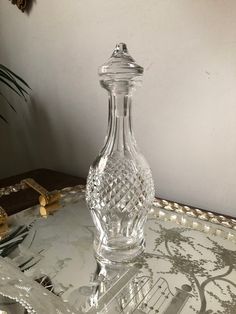 a clear glass bottle sitting on top of a tray