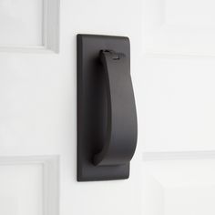 a black door handle on a white door