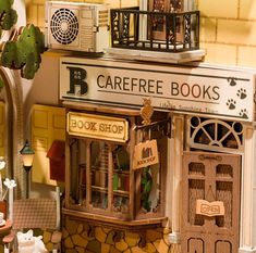 there is a miniature store with lots of books on the front and shelves in it