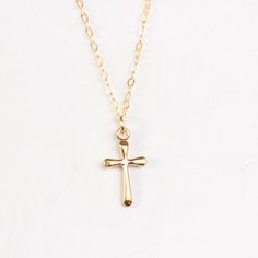 "14k Gold fill cross necklace - the perfect religious necklace. Model is wearing 18\" . This necklace is made of.... -14k gold fill 15.5 x 8.5mm and -14k gold fill chain with spring clasp, -Come up with beautiful ribbon gift box and -One set of Care instruction package. LAYERED NECKLACES https://www.etsy.com/shop/rainbowearring1?section_id=17891444&ref=shopsection_leftnav_5 COIN / DISC NECKLACES https://www.etsy.com/shop/rainbowearring1/search?search_query=coin+necklace&order=date_desc&a 14k Gold Filled Cross Necklace Gift, 14k Gold Filled Cross Charm Necklace For Gift, 14k Gold Filled Cross Charm Necklace As Gift, 14k Gold Filled Cross Pendant Necklace As Gift, Simple Gold Cross Pendant Necklace, 14k Gold Filled Cross Necklace, Jewelry Cross Necklace, Small Cross Necklace, Catholic Baptism