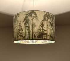 a lampshade hanging from the ceiling in a room with a painting on it