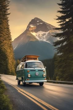 an old vw bus driving down the road with mountains in the backgroud