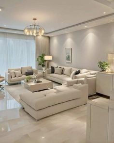 a living room filled with lots of white furniture