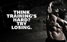 a man standing in front of a wall with the words think training's hard, try losing