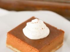 a piece of pumpkin pie with whipped cream on top