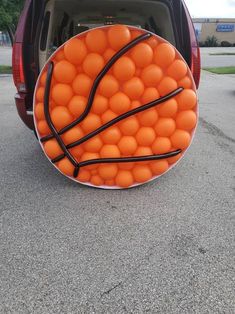 an orange basketball ball in the back of a car that is filled with lots of balls