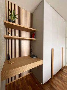 a room with some shelves on the wall and a plant sitting on top of it