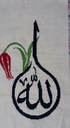 an embroidered piece of cloth with the word eid written in arabic