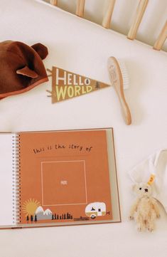 there is a book, teddy bear, and toothbrush next to it on the bed