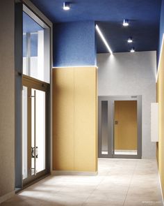 an empty hallway with two elevators and blue ceiling lights on the walls in front of them