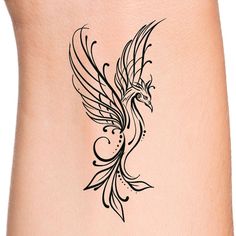 a tattoo design on the side of a woman's stomach, with a bird in flight