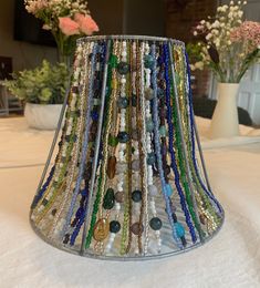 a lamp shade that has many beads on it