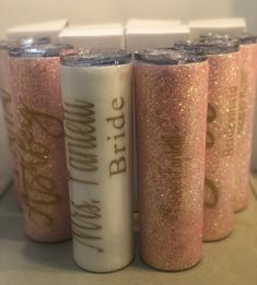 four pink glittered tumbles with the words bride and groom written on them are lined up next to each other