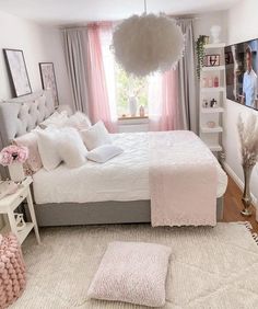 a bedroom with white and pink decor on the walls, carpeted flooring and a large bed