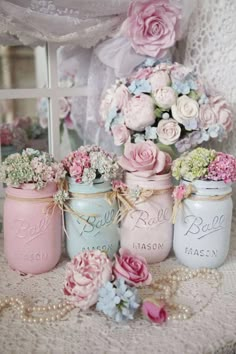 there are many jars with flowers in them