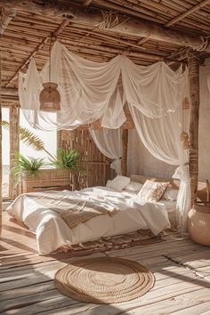 a bed sitting on top of a wooden floor under a canopy