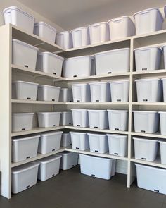 the shelves are filled with plastic containers and bins for storing items or other things