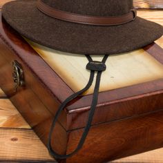 Western Chinstrap is an adjustable strap that can further secure the fit of your hat. It can be attached to any Panama, straw, or wool felt hat that contains a stitched-in sweatband. Simply slide the metal pins between the sweatband and inner hat, on both sides of the hat. It is made of 100% genuine cowhide leather. Easy installation. Caution: Follow the included instructions carefully to prevent any damage to the hat or sweatband. Should fit onto almost any straw Panama or felt hat. Securely ke Classic Adjustable Brown Felt Hat, Adjustable Country Style Fedora Felt Hat, Adjustable Brown Hats For Hunting, Country Style Adjustable Felt Hat With Short Brim, Adjustable Brown Fedora Felt Hat, Adjustable Western Felt Hat For Everyday, Adjustable Flat Brim Hunting Hat, Adjustable Brown Country Style Hat Bands, Adjustable Brimmed Country Style Felt Hat