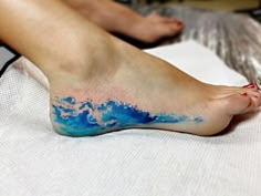 a person with blue and white paint on their feet