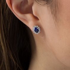 Striking and splendid, these fashion stud earrings deliver eye-catching style. Crafted in cool 10K white gold, each glamorous earring features a 6.0 x 4.0mm oval-shaped lab-created bright blue sapphire wrapped in a starburst frame of shimmering petite diamonds - each artfully set to enhance size and sparkle. Radiant with 1/6 ct. t.w. of diamonds and a brilliant buffed luster, these post earrings secure comfortably with friction backs. White Gold Gemstone Cluster Earrings, Fine Jewelry White Gold Cluster Earrings With Gemstones, White Gold Gemstone Cluster Earrings Fine Jewelry, Bright Blue, Post Earrings, Blue Sapphire, Sapphire, Sparkle, White Gold