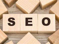 wooden blocks spelling the word seo on top of each other, surrounded by smaller wood cubes