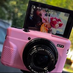 a pink camera sitting on top of a table