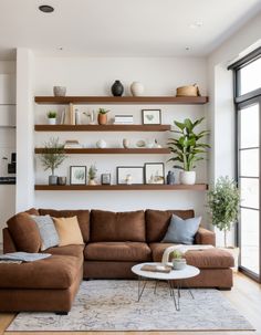 a living room filled with furniture and lots of shelves on the wall above it's couch