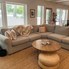 a living room filled with furniture and large windows