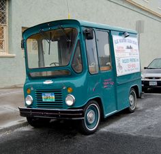 an ice cream truck parked in front of a building