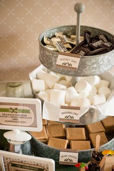 there are many different types of marshmallows in the tray on this table