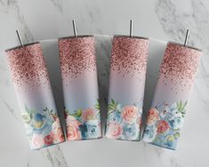 four pink, blue and white flowers are on top of each other in front of a marble background