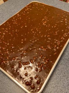 a pan filled with brown liquid sitting on top of a counter