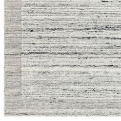 an area rug with black and white stripes on the side, in shades of gray