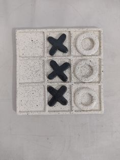 a black and white ceramic object with x on it