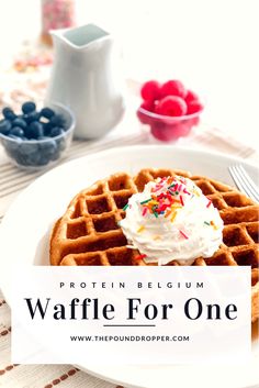 waffles with whipped cream and sprinkles are on a white plate