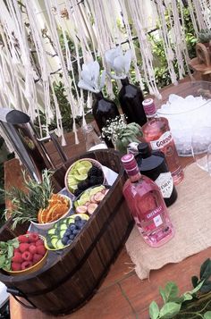 a picnic table with fruit and drinks on it