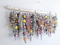 an arrangement of flowers hanging on a wall