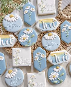 decorated cookies with daisies and the words nive on them