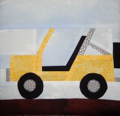 a quilted pillow with a yellow truck on it