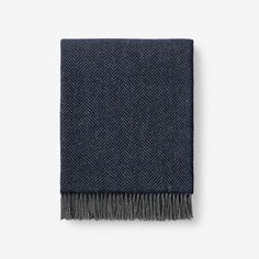 a black and grey herringy blanket with fringes